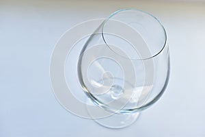 Empty glass goblet on a white background