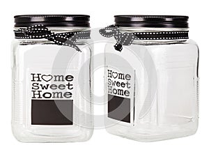 Empty glass jar with black metal lid decorated with words `Home sweet home`