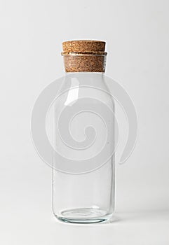 Empty glass jar with brown corke isolated on white background