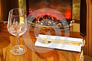 Empty glass, knife and fork on table