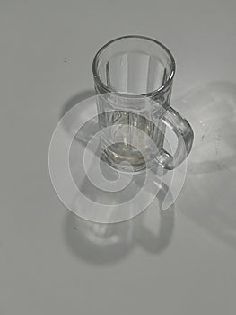 An empty glass with multiple shadow