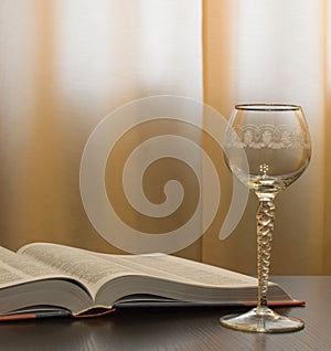 Empty glass and open book