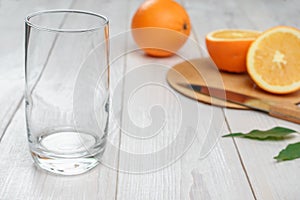 Empty glass and oranges in the background