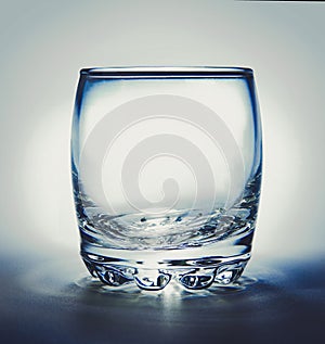 Empty glass with reflection on white background