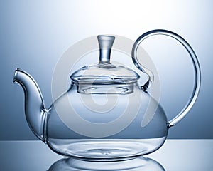 Empty glass teapot on a gray background
