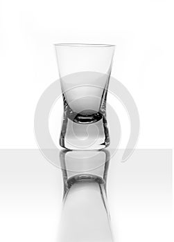 Empty glass of vodka, white background