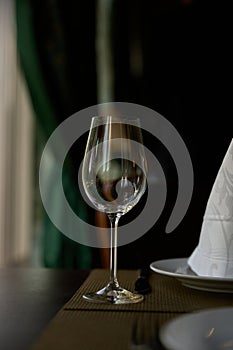 An empty glass of wine on a table in a restaurant. Isolated.