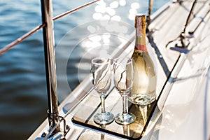 Empty glasses and bottle with champagne with sea background