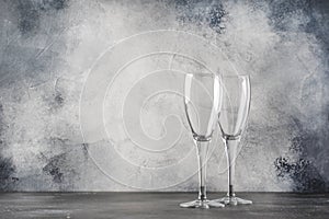 Empty glasses for champagne or sparkling wine, gray background, copy space, selective focus