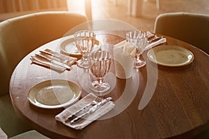 Empty glasses and dishes set in restaurant