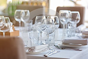 Empty glasses in restaurant background. Table set for an event party or wedding reception.