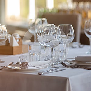 Empty glasses in restaurant background. Table set for an event party or wedding reception.