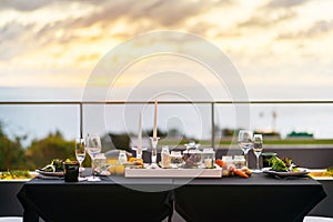 Empty glasses set in restaurant - Dinner table outdoors at sunset