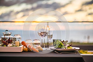 Empty glasses set in restaurant - Dinner table outdoors at sunset