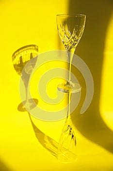 Empty glasses stand on a yellow background.Sunlight is refracted through the glass.Trending images