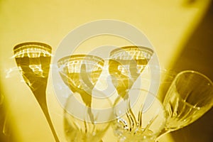 Empty glasses stand on a yellow background.Sunlight is refracted through the glass.Trending images