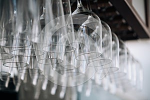 Empty glasses for wine above a bar rack. Hanging