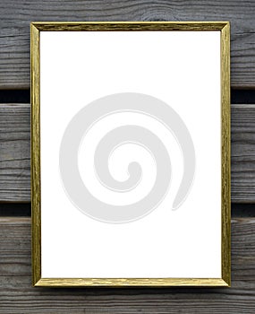 Empty golden picture frame on wooden wall