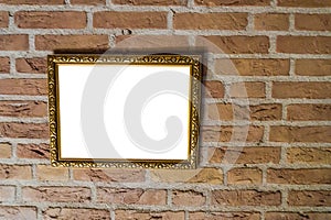 Empty golden vintage painting frame hanging on a brick wall background