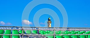 Empty grandstand on the Baltic Sea beach in WarnemÃÂ¼nde with a lighthouse as a panoramic background