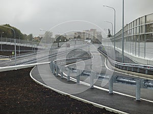 Empty gray highway to the horizon. Road junction in front