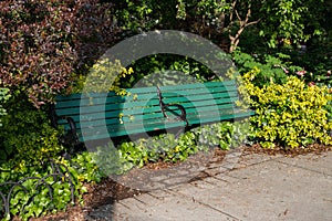 Empty Green Bench with Plants at Van Vorst Park in Jersey City New Jersey during Spring