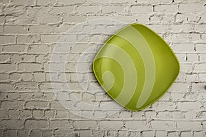 Empty green ceramic dish plate, on gray background. Top view with copy space.