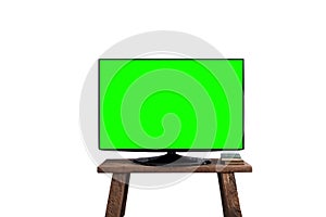 Empty green flat TV screen on wood stand .