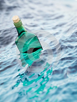 Empty green glass bottle in the sea