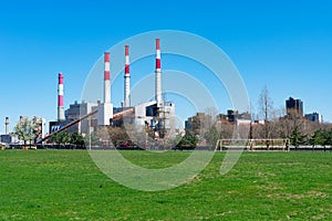 Empty Green Grass Field on Roosevelt Island with a view of a Power Plant in New York City