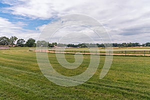 Empty green grass race track for horse racing on summer sunny day