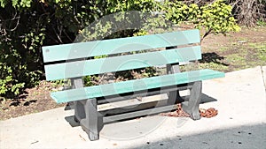 empty green gray solo single wood wooden bench park outside on pavement cement 137 v