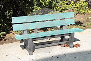 empty green gray solo single wood wooden bench park outside on pavement cement 168 p 17