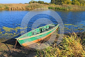 The empty green wooden boat
