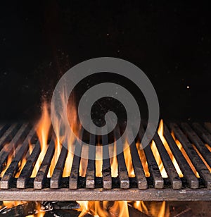 Empty grill grate and tongues of fire flame. Barbeque night background