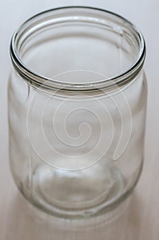 Empty half-liter glass jar on the table closeup