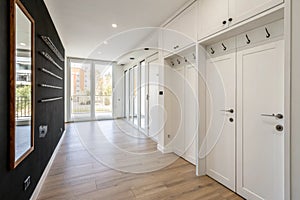 Empty hallway with white doors and black wall in modern apartment