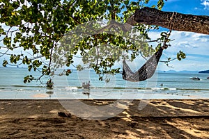 Empty hammock hanging on the tree on a tropical island with a beautiful beach, Krabi, Thail