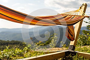 Empty hammok hanging in the mountains in summer