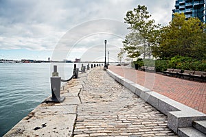 Empty harbourside path on a cloudy autumn day