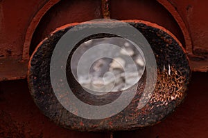 Empty hawse in old red rusted ship hull