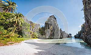 Empty hidden beach in morning sun light at El Nido, Palawan, Philippines. Holiday vacation destination