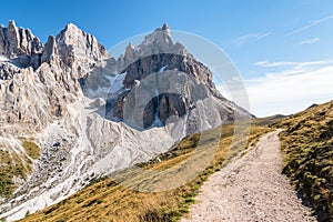 Deserted winding alpine path on a clear autumn day