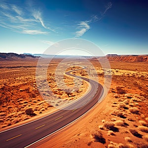 An empty highway is captured from a top-down perspective, offering an aerial view of the great landscape it traverses