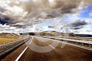 Empty highway,mountain landscape and cloudy sky.Road and car travel concept