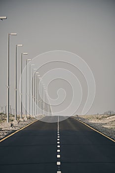 Empty highway with street lamps