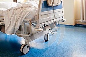 Empty hospital bed on hospital ward