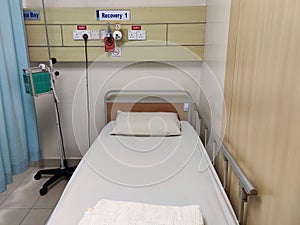 An empty hospital bed. It is in a state of readiness to accept patients.