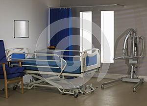 empty hospital ward with bed chair and hoist