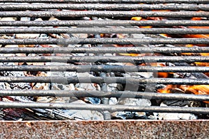 Empty hot charcoal barbecue BBQ grill with burning fire with flame and smoke. Hot coal made of greatly heated wood